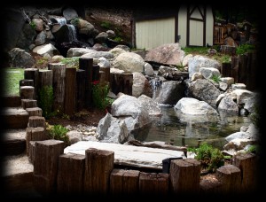 Raised pond with railroad tie border keeps kids and pets out of the water